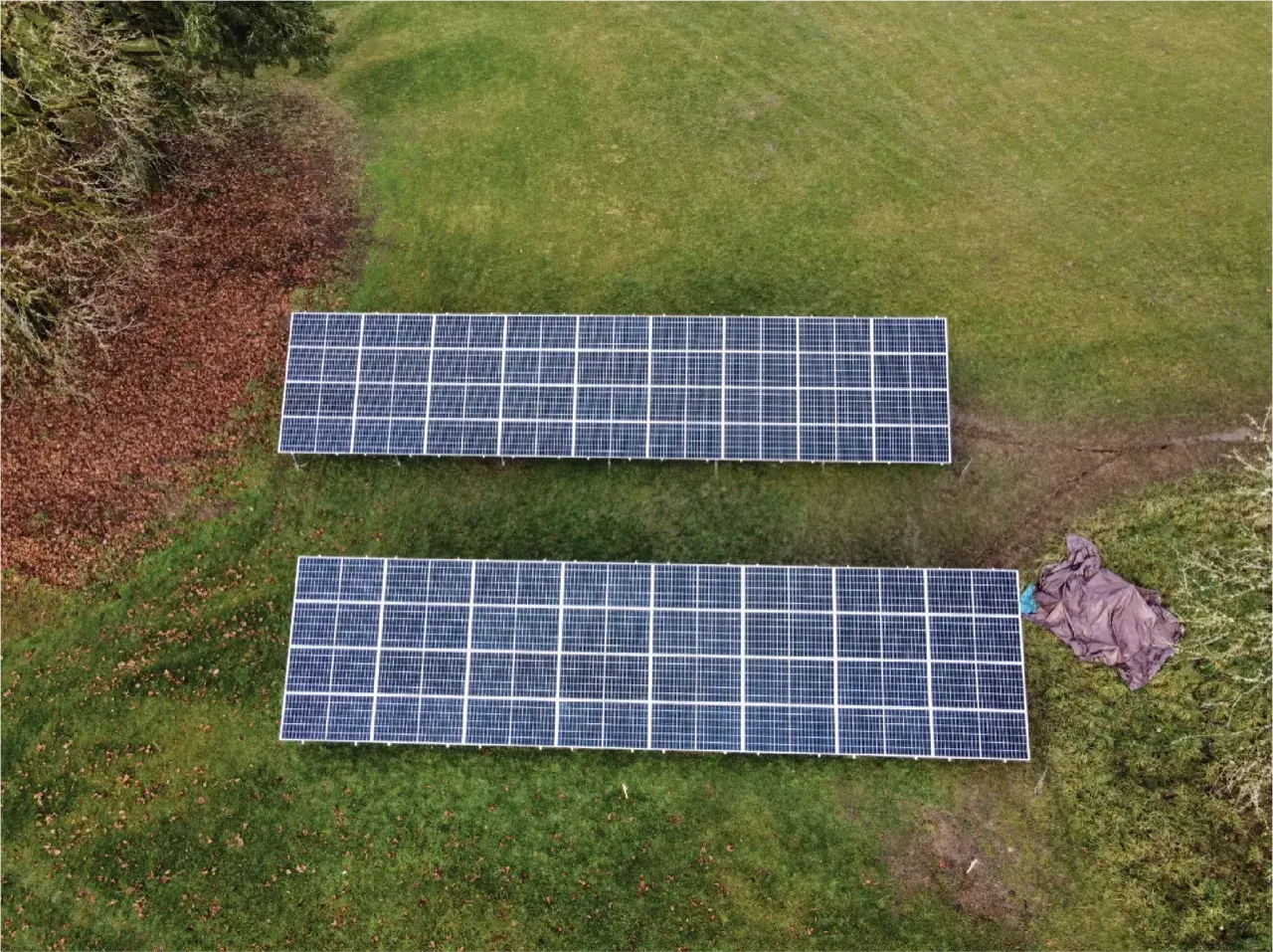 Ground-mounted solar panels in a grassy field